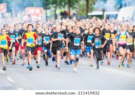 STOCKHOLM - AUG, 16: Closeup after the chaotic start when the young kids runs in the Midnight Run for children (Lilla Midnattsloppet) event. Aug 16, 2014 in Stockholm, Sweden