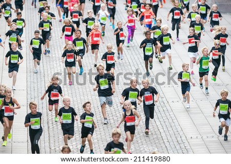 STOCKHOLM - AUG, 16: Big group from above after the first curve of the youngest in the Midnight Run for children (Lilla Midnattsloppet) event cheered on. Aug 16, 2014 in Stockholm, Sweden