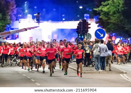 STOCKHOLM - AUG, 16: Leaders in one of the many groups just after start of the Midnight Run (Midnattsloppet) event. Aug 16, 2014 in Stockholm, Sweden
