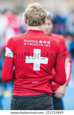 STOCKHOLM - AUG, 23: Triathlete from Switzerland in red jacket with white cross preparing at the Mens ITU World Triathlon Series event Aug 23, 2014 in Stockholm, Sweden