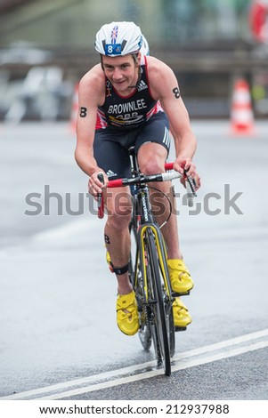 STOCKHOLM - AUG, 23: Alitstair Brownlee with Jonathan on slipstream into a curve in the rain at the Mens ITU World Triathlon Series event August 23, 2014 in Stockholm, Sweden