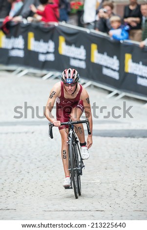 STOCKHOLM - AUG, 23: Baiba Medne from Latvia fixing her shoes after the transition to cycling at the Womans ITU World Triathlon Series event August 23, 2014 in Stockholm, Sweden