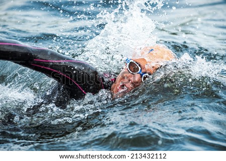 STOCKHOLM - AUG, 23: Closeup of a triathlete swimming in the cold water at the Womans ITU World Triathlon Series event August 23, 2014 in Stockholm, Sweden