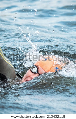 STOCKHOLM - AUG, 23: Closeup of a triathlete swimming in the cold water at the Womans ITU World Triathlon Series event August 23, 2014 in Stockholm, Sweden