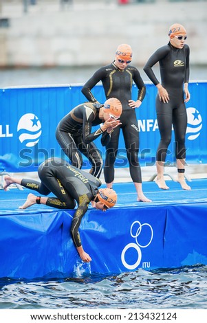 STOCKHOLM - AUG, 23: Triathletes prepare before the womens swimming in the cold water at the Woman ITU World Triathlon Series event Aug 23, 2014 in Stockholm, Sweden