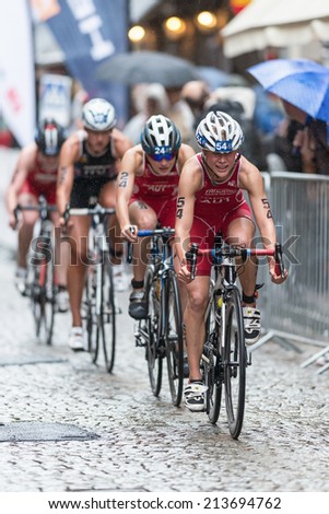 STOCKHOLM - AUG, 23: Julia Hauser leading a group of women triahtletes in the rain in the old town at the Womans ITU World Triathlon Series event August 23, 2014 in Stockholm, Sweden