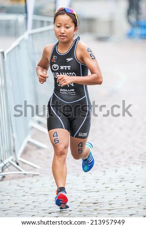 STOCKHOLM - AUG, 23: Aoi Kuramoto from Japan at the cobblestone roads of the old town in the Womens ITU World Triathlon Series event Aug. 23, 2014 in Stockholm, Sweden