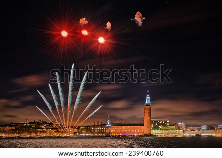STOCKHOLM, DEC 22: Night photography of the city center with the town hall in Stockholm, clear sky with stars and fireworks. December 2014 in Stockholm, Sweden