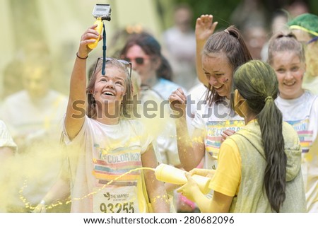 STOCKHOLM, SWEDEN - MAY 23: Girls taking happy selfies at Stockholm Color Run in Tantolunden or Tanto on May 23, 2015. People from all walks of life participated in the run.