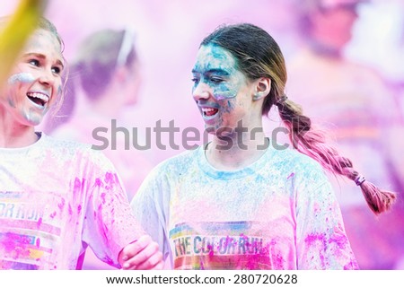 STOCKHOLM, SWEDEN - MAY 23: Two happy colorful girls in purple at Stockholm Color Run in Tantolunden or Tanto on May 23, 2015. People from all walks of life participated in the run.
