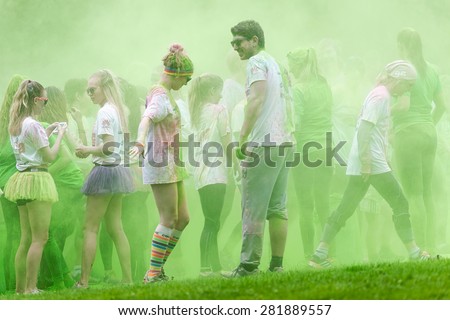 STOCKHOLM, SWEDEN - MAY 23: Happy people passing the green color station at Stockholm Color Run on May 23, 2015. People from all walks of life participated in the run.