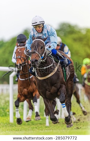 STOCKHOLM - JUNE 6: Jockey and horse leading during action filled horserace at the Nationaldags Galoppen at Gardet. June 6, 2015 in Stockholm, Sweden.