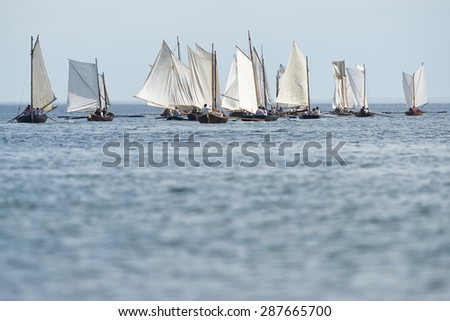 GRISSLEHAMN - JUN 13, 2015: Group of old sailing ships rowing towards the horizon from Grisslehamn (Sweden) to Eckero (Aland) in the public event Postrodden, June 13, 2015 in Grisslehamn, Sweden