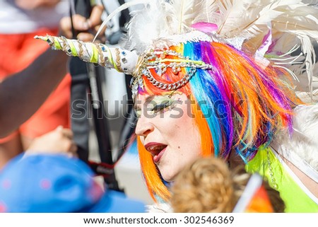 STOCKHOLM, SWEDEN - AUGUST 1, 2015: Person in rainbow hair and unicorn costume at the Pride parade in Stockholm. Approx 400.000 spectators at the streets.