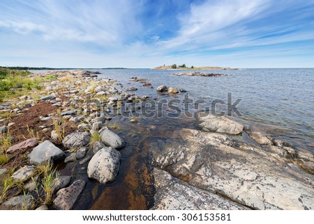 Coastal scene with vegetation on the round rocks at seafront during summer. Grisslehamn, Sweden