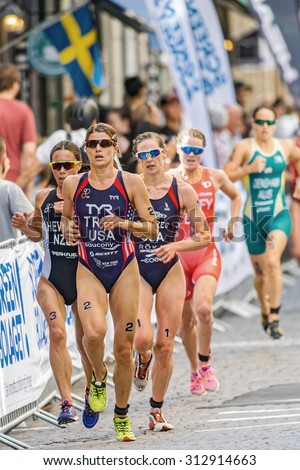 STOCKHOLM - AUG 22, 2015: Sarah True (USA) leading before the other podium winners (Hewitt, Zeferes) at the cobblestones in the Womens ITU World Triathlon series event in Stockholm.
