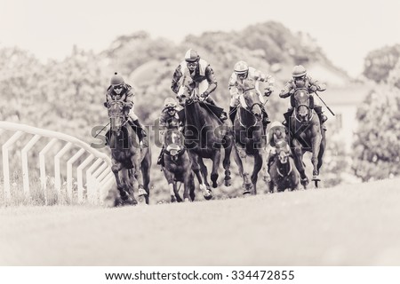 STOCKHOLM, SWEDEN - JUN 6, 2015: Horses with jockeys out of a curve in fast pace at Nationaldagsgaloppen at Gardet. Sepia filter applied