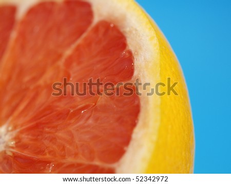 The red grapefruit on blue background