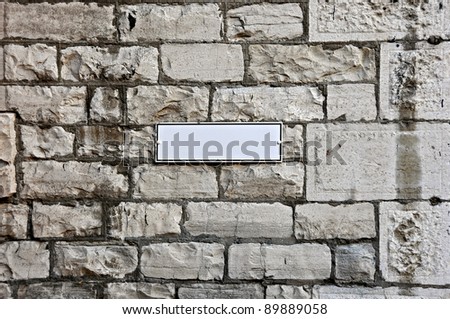 Stone wall with empty placard