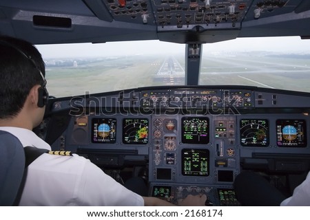 Plane Pilot on Cockpit View Of An Airline Pilot About To Land On Final Approach Stock