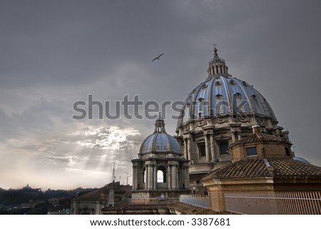 two cupola domes of St. Peter\'s Basilica with a dazzling sunburst background and a soaring bird