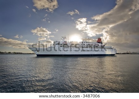 cruise liner leaving at sunset