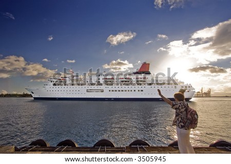 Person waving goodbye to the passengers of a departing cruise ship