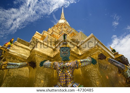 Statue of Demon (Yaksha), character from the Ramakien epic, at Golden Chedi at Wat Phra Kaew in Thailand