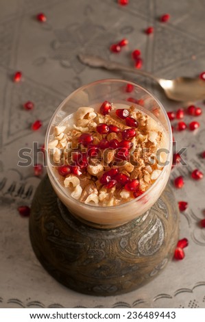 ashura or pudding Turkish dessert Ashura, Noah\'s pudding, with pomegranate seeds and walnuts