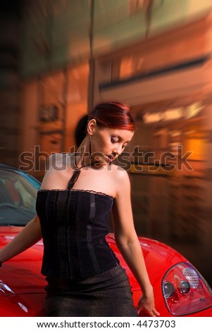 Beautiful young woman and the red sports car. With Clipping Path.