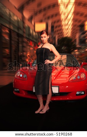 Pretty young woman and red sports car.
