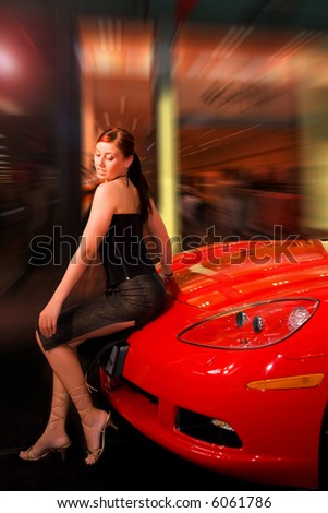 Pretty young woman and a red sport car.
