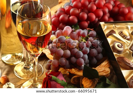 Red and white wine, fruits and rose.