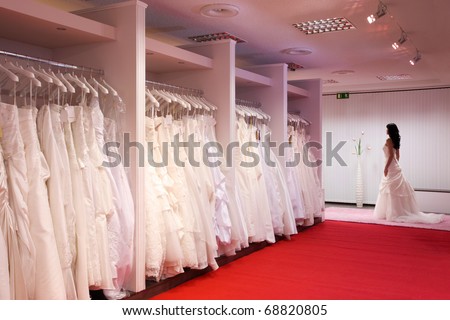 Pretty girl in a wedding gown in the bridal shop.