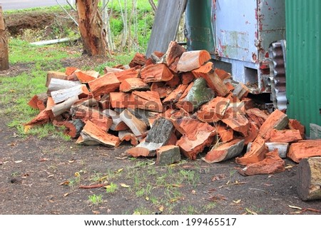 Cut and split Australian red gum fire wood pile, in country backyard