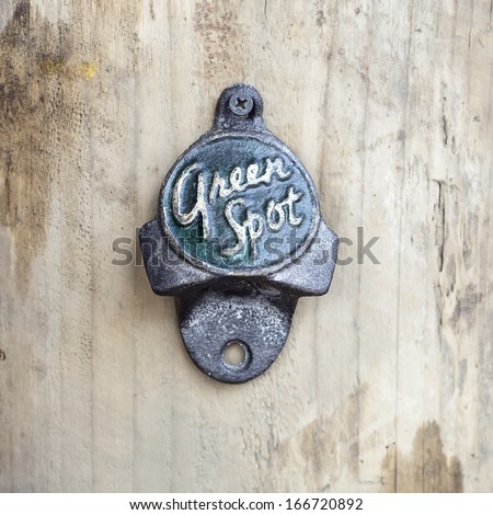 BANGKOK, THAILAND - DEC 5 : Old bottle opener with the logo of Green spot on December 5, 2013 in Bangkok, Thailand. It is a carbonated soft drink sold in stores and restaurants in Thailand.