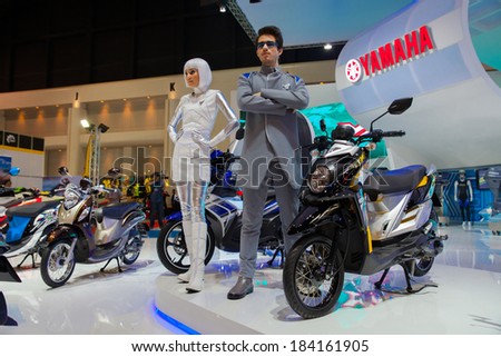 BANGKOK - MARCH 26 : Unidentified man and women presenter of new Models YAMAHA TTX motorcycle on display at The 35th Bangkok International Motor Show 2014 on March 26, 2014 in Bangkok, Thailand.