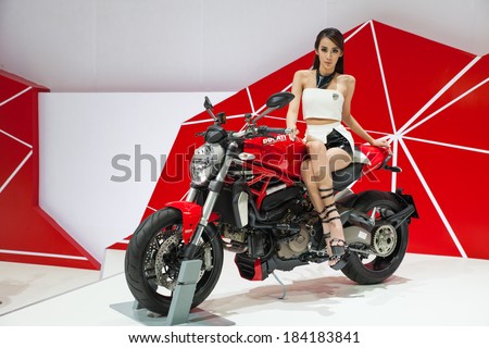 BANGKOK - MARCH 26 : Unidentified pretty women presenter of new Models Ducati Monster motorcycle on display at The 35th Bangkok International Motor Show 2014 on March 26, 2014 in Bangkok, Thailand.