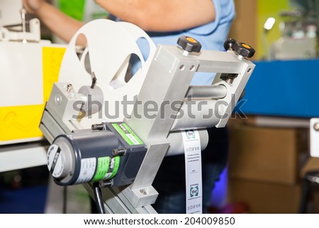 BANGKOK - JUNE 28 :Cutting the shirt labels  machine at Garment  Manufacturers Sourcing 2014 on June 28,2014 in BITEC ,Bangkok,  Thailand.