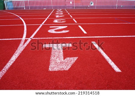 Red running track numbers one two three in stadium