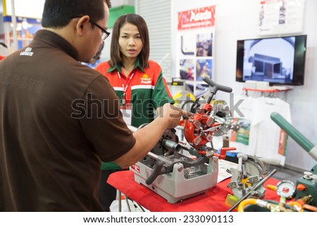 BANGKOK - SEPTEMBER 22 :Unidentified people interesting with   tapping tool METALEX 2014 on Nov 22,2014 in BITEC ,Bangkok,  Thailand.