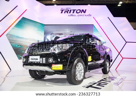 NONTHABURI - DESEMBER 4 :unidentified people  interest with All new Triton  on display at  MOTOR EXPO 2014 on Dec 4,2014 in Nonthaburi,  Thailand.