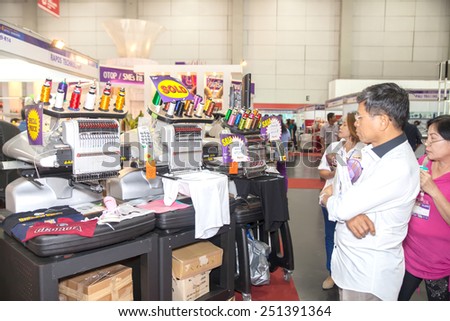 BANGKOK ,THAILAND - FEBRUARY 7: Unidentified people interest with  embroidery machine  THAILAND Industrial Fair 2015 And Food Pack Asia 2015  on February 7, 2015 in Bangkok, Thailand.
