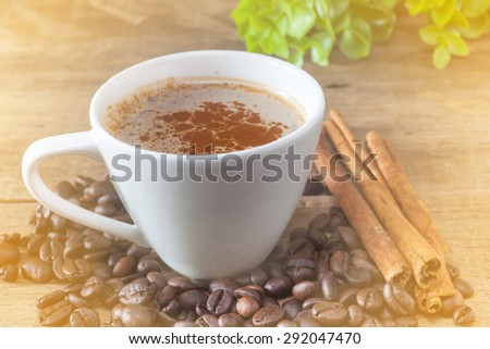 Hot coffee with cinnamon powder with worm light tone