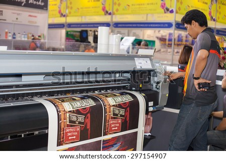 BANGKOK ,THAILAND - JULY 11: Unidentified people check with \
digital textile printer at Garment Manufacturers Sourcing Expo \
2015 (GFT 2015) , on JULY 11, 2015 in Bangkok, Thailand.