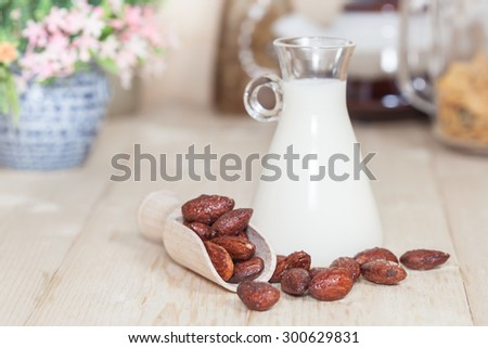 Almonds caramel with milk on table. Selective focus, shallow DOF