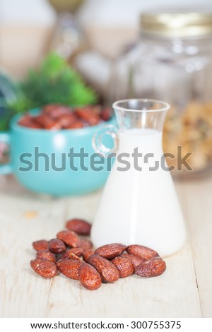 Almonds caramel with milk on table. Selective focus, shallow DOF