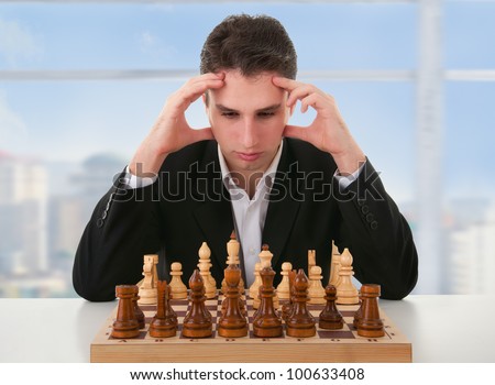 serious focused man thinks  on game of chess
