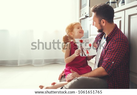 Father's day. Happy family daughter giving dad a greeting card on holiday
