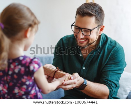 Father\'s day. Happy family daughter giving dad a gift on holiday